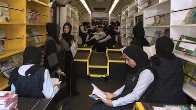 Grade 9 students of Al Raheeb School check out the books available in the mobile library. Jeffrey E Biteng / The National