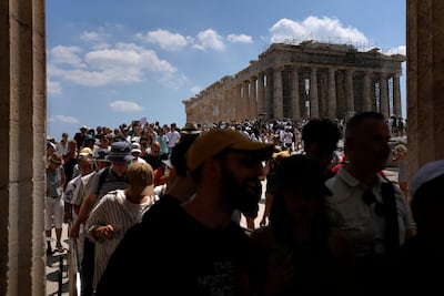 Tourists stream into the Parthenon temple on top of the Acropolis in Athens. AP Photo