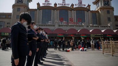 Railway staff pay tribute as China holds national mourning for those who died of the coronavirus disease, on the Qingming tomb-sweeping festival, at the Beijing Railway Station, April 4, 2020. Reuters