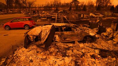 Two vehicles that endured the Carr Fire, one with minor cosmetic damage and one destroyed, rest among leveled homes in the Lake Keswick Estates area of Redding, California. AP Photo / Noah Berger