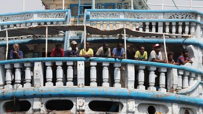 Yemeni fishermen standing on a large fishing boat in the southeastern port city of Mukalla. AFP