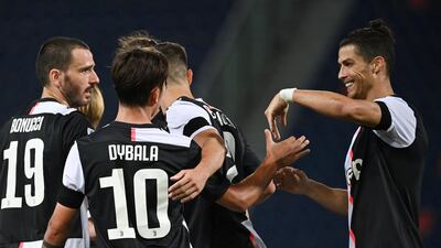Juventus' Paulo Dybala celebrates scoring with Cristiano Ronaldo, right, and teammates during the Serie A match against Bologna at Stadio Renato Dall'Ara on Monday. AP