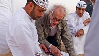 Christo Yavacheff, centre, meets with Liwa residents Khalfan Al Qubasi, left, and Saeed Al Falahi, right, to discuss his plans to construct in Liwa a pyramid of 415,000 oil drums that will be bigger than the main pyramid of giza. Antonie Robertson / The National