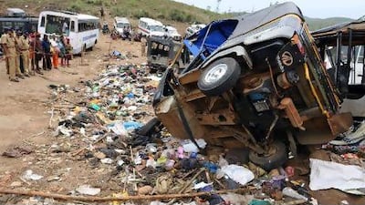Indian police personel and Hindu devotees stand near the accident spot at Pullumedu around 210 km northeast of southern Indian city of Kochi on January 15, 2010. More than 100 Hindu devotees were killed after a road accident triggered a stampede among thousands of pilgrims returning from an Indian religious festival at the hill shrine of Sabarimala.