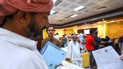 Residents who have overstayed their visa or worked without one wait to be seen in Al Raha Mall during a previous amnesty campaign. Victor Besa / The National