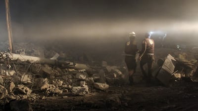 Members of a Syrian civil defence team, known as the White Helmets, search for survivors under the rubble of a building, following reported airstrikes on the Syrian town of Ibbin Semaan, in the western countryside of Aleppo. AFP