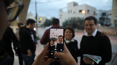 Ayman Odeh, Israeli Arab parliament member and leader of the Joint List alliance, poses for a photo with a supporter during an election campaign event in then town of Yabeh, West Bank. AP