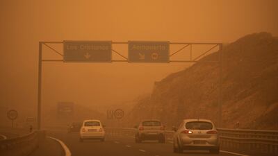 Cars drive on the TF-1 highway during a sandstorm in Santa Cruz de Tenerife. AFP