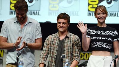 From left, Liam Hemsworth, Josh Hutcherson and Jennifer Lawrence attend the The Hunger Games: Catching Fire panel Day 4 of Comic-Con International. Jordan Strauss / Invision / AP