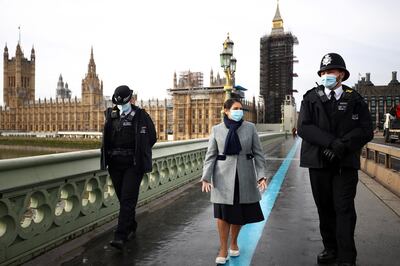 Home Secretary Priti Patel with police officers on Westminster Bridge in London. Reuters