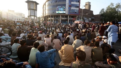 Fans gather to cheer on their side in Jalalabad, with the match being held in Trinidad. AP
