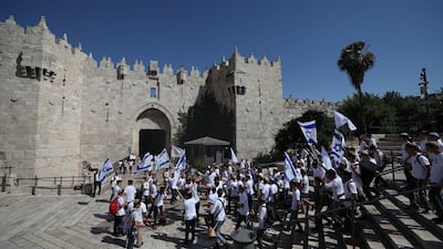 People wave Israeli flags during the 'Flag March'. EPA