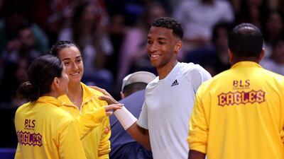Felix Auger- Aliassime of Kites is congratulated by Caroline Garcia of Eagles and Bianca Andreescu of Eagles after winning his men's singles match against Nick Kyrgios of Eagles. Getty