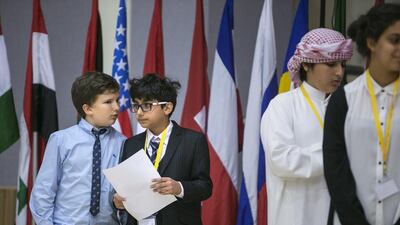 Tom Atkinson, 12, left, and an Al Yasmina pupil, with Abdullah Al Maini, 10, an Al Muna primary pupil, before they speak at the debate. Silvia Razgova / The National