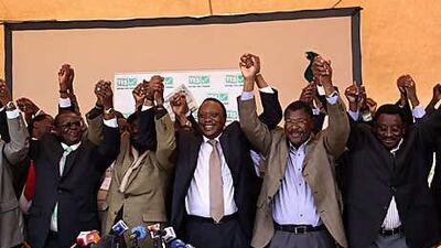 Cabinet ministers celebrate the provisional results in Nairobi yesterday. Below, voters queue at a polling station north of the capital.