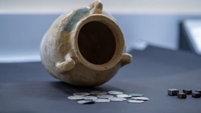 A haul of ancient coins from the Abbasid dynasty was discovered in this ancient pot by a team from Sharjah Archaeology Authority. Photo: Wam