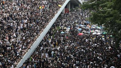 Protesters march along a road demonstrating against a proposed extradition bill in Hong Kong, China. Reuters