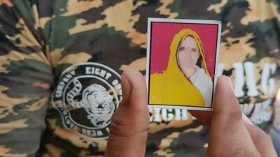 Rajesh Kumar Yogi, 30, showing his mother Jamuna Devi’s picture. She was attacked and mauled to death by a tiger near her fields in Sawai Madhopur in Rajasthan in February 2019. Taniya Dutta / The National