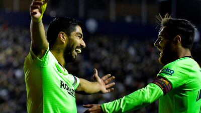 Luis Suarez celebrates a goal with Lionel Messi. AFP