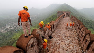Disaster response officers examine a watch tower struck by lightning near Amer Fort in Jaipur, India.