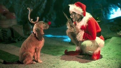 The grinch, played by Jim Carrey, conspires with his dog Max in How the Grinch Stole Christmas. Bloomberg News
