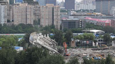 Workers demolish one of the last remaining sections of grandstand. AFP