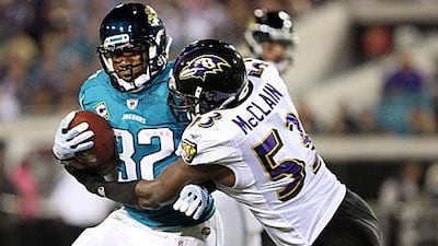 Maurice Jones-Drew, left, is tackled to the ground by the Baltimore linebacker Jameel McClain. The Jacksonville running back went 105 yards on 30 carries.