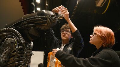 North Bergen High School's Xavier Perez, who plays the Alien, is covered in slime by his handlers Eddie Mantilla and Cassandra Klima as they work on the play. AP