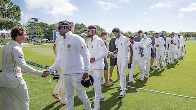 Sri Lanka's Angelo Mathews, right, shakes hands with New Zealand after his side lost the first Test on December 29, 2014. Marty Meville / AFP