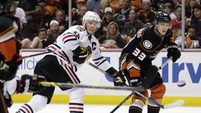Chicago Blackhawks' Jonathan Toews, left, shoots around Anaheim Ducks' Jakob Silfverberg during the third period in Game 7 of the Western Conference final of the NHL hockey Stanley Cup playoffs in Anaheim, Calif., Saturday, May 30, 2015. (AP Photo/Jae C. Hong)