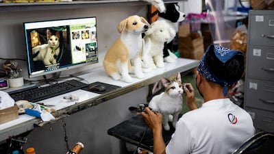 A worker paints the face of a realistic pet plushie, at the Pampanga Teddy Bear Factory, in Angeles City, Pampanga province, Philippines, March 10, 2023. REUTERS / Lisa Marie David TPX IMAGES OF THE DAY