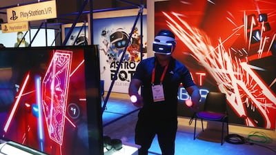 An attendee plays the PlayStation VR Beat Saber game. AP Photo