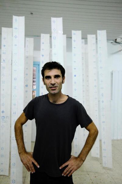 Akram Al Halabi with his piece on Golan identity. Courtesy Ryan Inouye