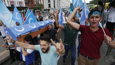 Uighurs living in Turkey and their supporters, some carrying coffins representing Uighurs who died in China's far-western Xinjiang region, chant slogans as they stage a protest in Istanbul on July 4, 2015. Emrah Gurel/AP Photo