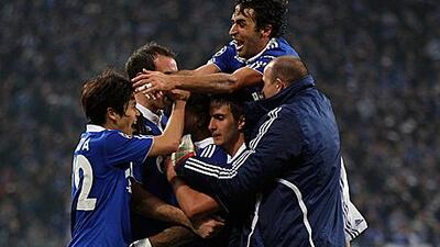 Schalke players celebrate after securing their passage into the Champions League quarter-finals after a 4-2 aggregate win against Valencia.