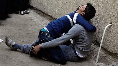 The sons of Abbas Lazim grieve outside hospital after their father was killed in a bomb attack in Sadr City in Iraq yesterday.