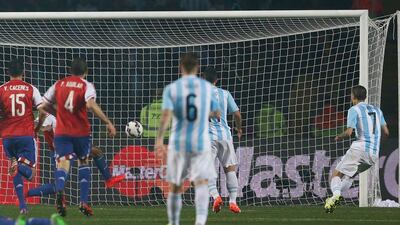 Argentina's Angel Di Maria, right, scores his side’s fourth goal six minutes later to make it 4-1 against Paraguay in the Copa America semi-final on Tuesday night. Andre Penner / AP