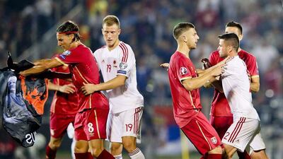 After Stefan Mitrovic tore down the flag, Albanian players responded angrily, with a fight ensuing, sparking the violent fan reaction. Srdjan Suki / EPA