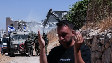 Israeli security forces demolish a Palestinian home and shops near the Beit Hagai settlement, south of Hebron. AFP