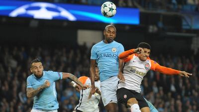 Manchester City's Fernandinho, centre, heads the ball clear as Shakhtar's Taison challenges for the ball. Rui Vieira / AP Photo
