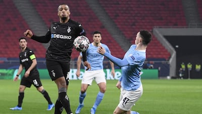 Monchengladbach forward Alassane Plea and Manchester City's midfielder Phil Foden battle for the ball in Budapest. AFP