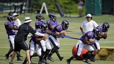 Baltimore Ravens running back Justin Forsett (29) and fullback Kiero Small (35) run a drill with teammates during NFL football training camp, Thursday, Aug. 6, 2015, in Owings Mills, Md. (AP Photo/Patrick Semansky)