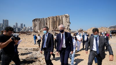 French Foreign Trade Minister Franck Riester, right and the French Ambassador to Lebanon Anne Grillo, visit Beirut's port, devastated in a massive deadly explosion in August last year. AP
