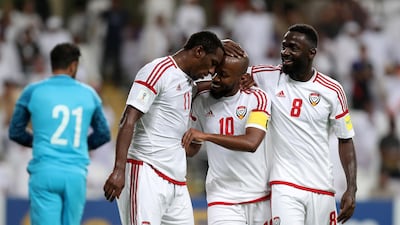 Ahmed Khalil, left, is congratulated by teammates after scoring the winner in a 2-1 win against Saudi Arabia. Chris Whiteoak / The National