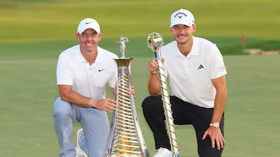 Race to Dubai winner Rory McIlroy and DP World Tour Championship winner Nicolai Hojgaard on the 18th green at the Earth Course at Jumeirah Golf Estates on November 19, 2023. Getty Images