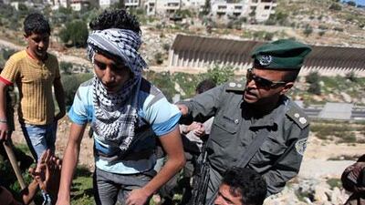 Palestinian protesters argue with Israeli soldiers during a demonstration against Israel's separation barrier in the West Bank village of Beit Jalla earlier this month.