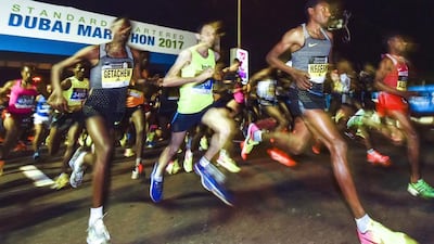 The Dubai Marathon course is perhaps unique in allowing participants to race alongside elite runners. AFP