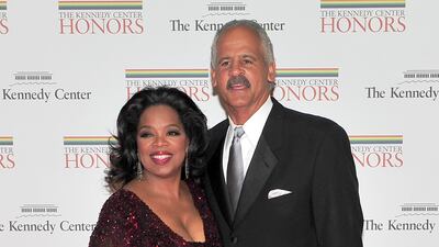 Oprah Winfrey wears sparkling burgundy to arrive at the formal Artist's dinner held at the State Department with Stedman Graham on December 4, 2010. EPA