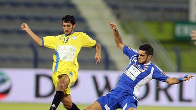 Ali Al Hammadi, left, is challenged by Humaid Ahmed of Al Nasr in Al Dhafra's 2-1 win. Ashraf Al Amra / Al Ittihad