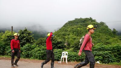 Thai rescuers head to the cave entrance. EPA